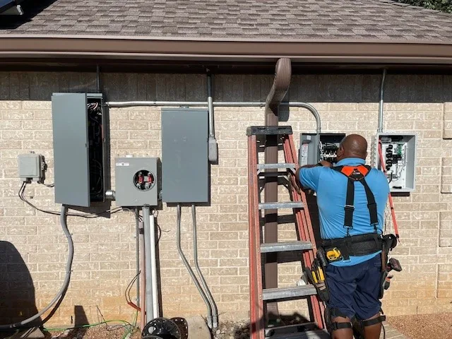 Electrician working on exterior electrical equipment
